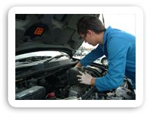 mechanic working on part of car engine