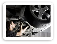 mechanic working underneath car